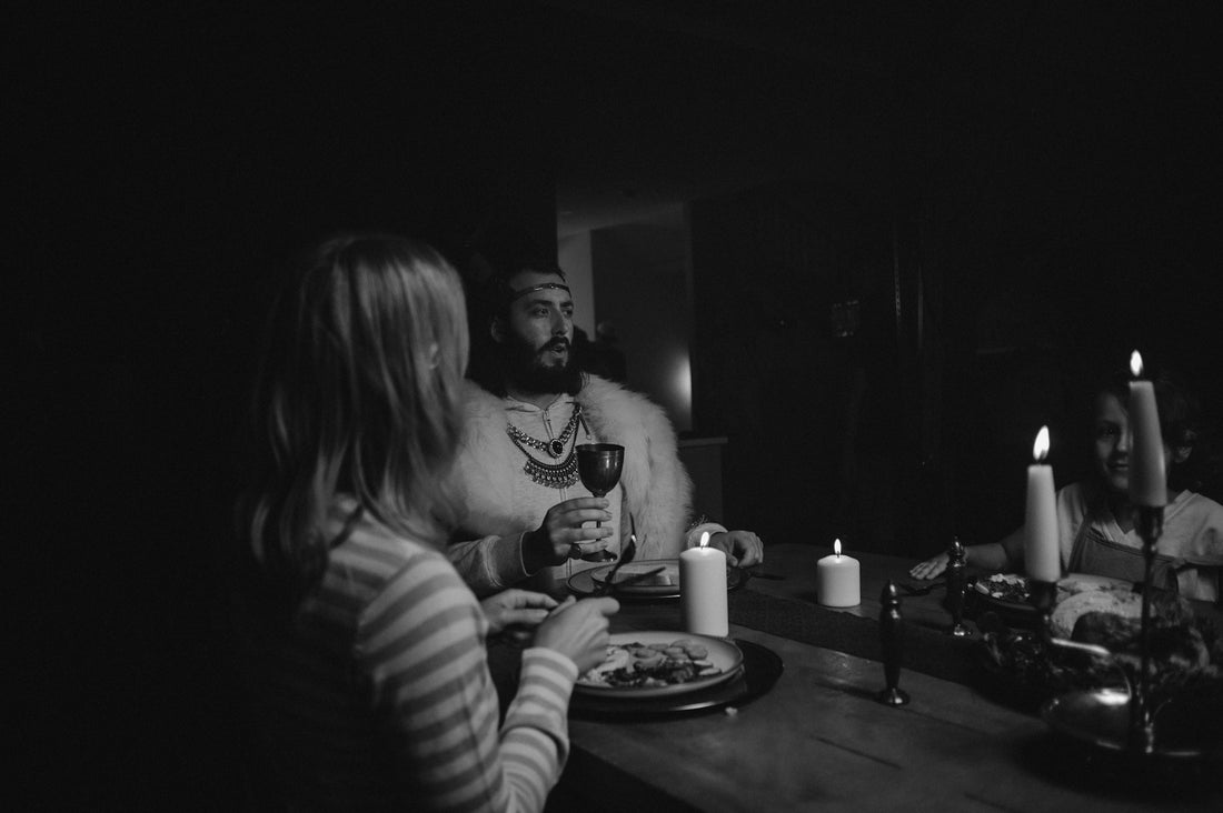 People dining by candlelight in dark room